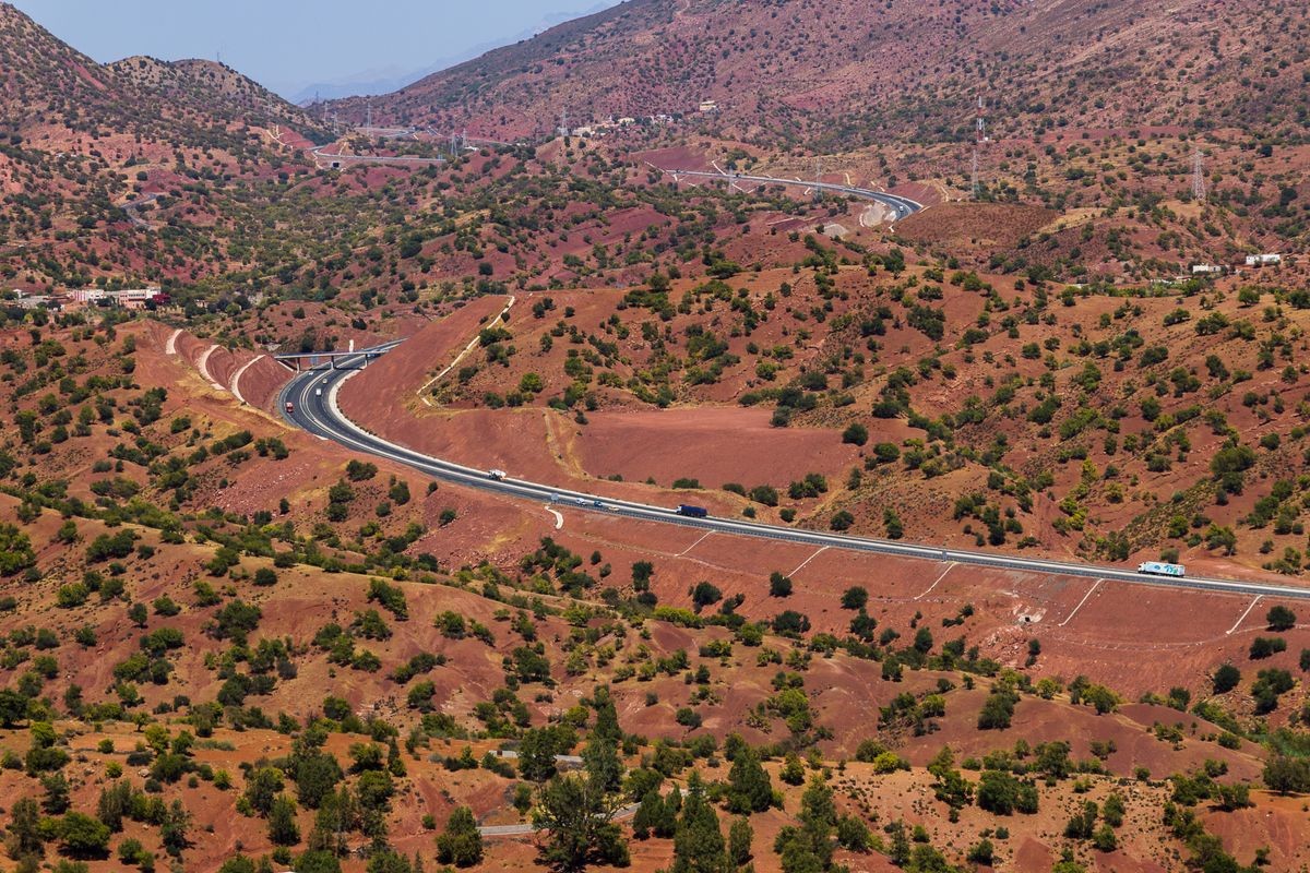 A modern highway weaves through the red terrain between Agadir & Marrakesh.